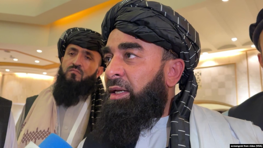 FILE - Zabihullah Mujahid, chief Taliban spokesperson, talks with reporters in Doha, Qatar, June 30, 2024.