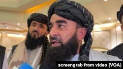 Zabihullah Mujahid, chief Taliban spokesperson, talks with reporters in Doha, Qatar, June 30, 2024.
