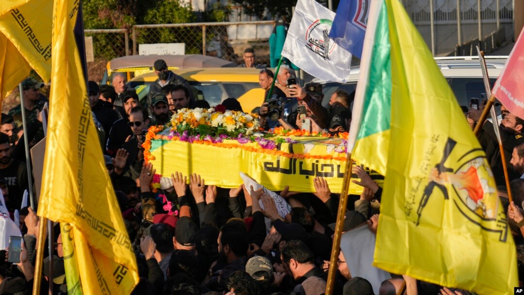 Fighters of the Popular Mobilization Forces carry the coffin of Wisam Mohammad al-Saedi, a commander of the Kataib Hezbollah paramilitary group, who was killed in a U.S. drone strike, in Baghdad, Iraq, Feb. 8, 2024.
