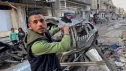 A man gestures in front of the car in which three sons of Hamas leader Ismail Haniyeh were reportedly killed in an Israeli airstrike in al-Shati camp, west of Gaza City on April 10, 2024.