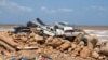 Damaged cars sit in a pile after a powerful storm and heavy rainfall hit in Derna, Libya, Sept. 12, 2023. 