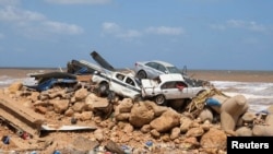 Damaged cars are piled up after a powerful storm and heavy rainfall hit in Derna, Libya, Sept. 12, 2023. 
