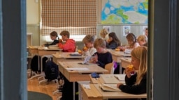 Students read at the Djurgardsskolan elementary school in Stockholm, Sweden, Thursday, Aug. 31, 2023. (AP Photo/David Keyton)