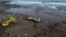 This aerial photo shows a veterinarian team conducting an examination on a dead sperm whale on Yeh Leh beach in Jembrana, Bali, April 9, 2023.