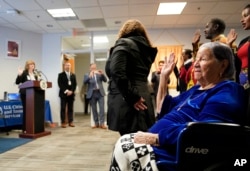 Maria Valles Bonilla, 106, right, recites the Oath of Allegiance during a naturalization ceremony at U.S. Citizenship and Immigration Services office, Tuesday, Nov. 6, 2018, in Fairfax, Va. (9AP Photo/Pablo Martinez Monsivais)