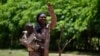 (FILE) A mother of four children, gestures as she is photographed at the village of Binmar, Chad, Friday, July 19, 2024.