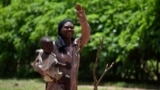 (FILE) A mother of four children, gestures as she is photographed at the village of Binmar, Chad, Friday, July 19, 2024.