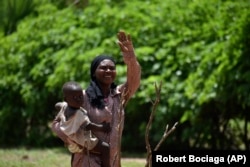 Marie Depaque, a mother of four children, gestures as she is photographed at the village of Binmar, Chad, Friday, July 19, 2024. (AP Photo/Robert Bociaga)