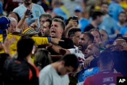 Uruguay's players argue with fans at the end of a Copa America semifinal soccer match against Colombia in Charlotte, NC, July 10, 2024.