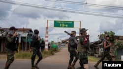 FILE - Volunteer members of Karenni insurgent forces walk in Moe Bye in Kayah State, Myanmar Nov. 12, 2023. 