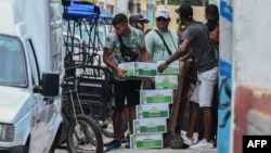 (FILE) Workers load boxes of beer to supply a private business in Havana, on June 6, 2023.