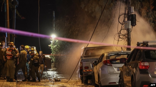 Israeli security forces stand at the scene of a rocket attack from the Gaza Strip in Jaffa amid the ongoing battle between Israel and Hamas, Nov. 14, 2023.