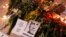 This photograph taken on Feb. 17, 2024, shows portrait placards, flowers and candles displayed as a tribute in Paris to Alexey Navalny after the announcement that the Kremlin's critic had died in an Arctic prison. China described Navalny's death as 'Russia's internal affair.'