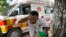 Jitendra Kumar, a paramedic who travels in ambulance, washes his face with water to cool himself off after dropping a patient at Lalitpur district hospital, in Banpur, in Indian state of Uttar Pradesh, June 17, 2023.