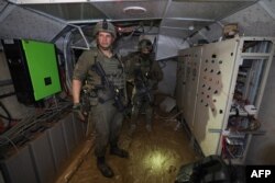 This photo, taken during a Feb. 8, 2024, media tour organized by the Israeli military, shows Israeli soldiers inside a tunnel that the army claims is a "Hamas command tunnel" under a compound of the UNRWA in Gaza City.