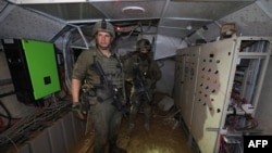 This photo, taken during a Feb. 8, 2024, media tour organized by the Israeli military, shows Israeli soldiers inside a tunnel that the army claims is a "Hamas command tunnel" under a compound of the UNRWA in Gaza City.