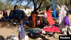 FILE - Families displaced in Muhajiriya, sit at Zamzam IDP camp in North Darfur.