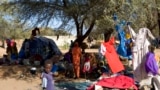 FILE - Families displaced by the recent fighting in Muhajiriya, sit at Zamzam camp in North Darfur February 5, 2009.