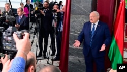 In this photo provided by the Belarusian Presidential Press Service, President Alexander Lukashenko addresses the media after voting, at a polling station in Minsk, Belarus, Feb. 25, 2024.