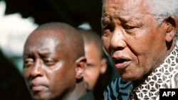 FILE - Former South African president Nelson Mandela meets with playwright Mbongeni Ngema, at Mandela's home in Johannesburg, June 17, 2002.