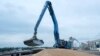 FILE - An excavator loads grain into a cargo ship at a grain port in Izmail, Ukraine, on April 26, 2023.