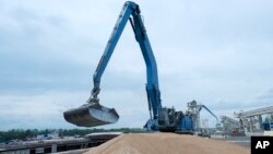 FILE - An excavator loads grain into a cargo ship at a grain port in Izmail, Ukraine, on April 26, 2023.