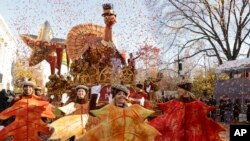Parade performers lead the Tom Turkey float down Central Park West at the start of the Macy's Thanksgiving Day parade, Nov. 23, 2023, in New York. 