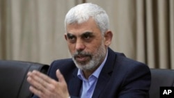FILE - Yahya Sinwar, head of Hamas in Gaza, attends a meeting at his office in Gaza City, April 13, 2022.