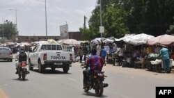 A general view of a street appearing calm with traffic normal in Niamey on July 26, 2023 as Nigerien President Mohamed Bazoum is held by guards according to a source close to Bazoum.