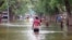 In this image from video, residents move through floodwaters in the town of Beledweyne, Somalia, Nov. 19, 2023. 