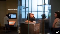 People visit exhibits inside the Smithsonian Hall of Human Origins, July 20, 2023, at the Smithsonian Museum of Natural History in Washington. 