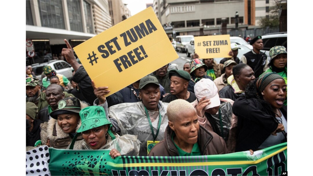 Supporters of former South African President Jacob Zuma stand outside the Electoral High Court in Johannesburg, April 8, 2024.