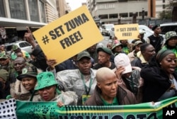 Supporters of former South African President Jacob Zuma stand outside the Electoral High Court in Johannesburg on April 8, 2024.
