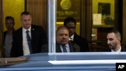 Manhattan District Attorney Alvin Bragg, center, leaves the district attorney's office in New York, March 30, 2023.