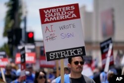 FILE - Members of the The Writers Guild of America picket outside Fox Studios on Tuesday, May 2, 2023, in Los Angeles. (AP Photo/Ashley Landis, File)