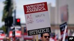 FILE - Members of the The Writers Guild of America picket outside Fox Studios on Tuesday, May 2, 2023, in Los Angeles. (AP Photo/Ashley Landis, File)