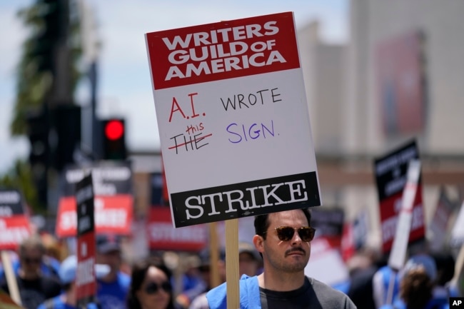 FILE - Members of the The Writers Guild of America picket outside Fox Studios on Tuesday, May 2, 2023, in Los Angeles. (AP Photo/Ashley Landis, File)