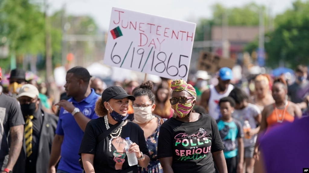 FILE - People march during a Juneteenth event on June 19, 2020, in Milwaukee. Juneteenth marks the day in 1865 when federal troops arrived in Galveston, Texas, to ensure all enslaved people were freed. (AP Photo/Morry Gash)