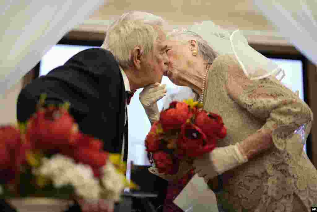 Linda Kalayci kisses her husband of 57 years, Tanzer Kalayci, after they renewed their vows during a Valentine's Day ceremony at the Memory Care center in the Palace at Weston senior living community, Feb. 14, 2024, in Weston, Florida.