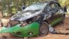 A car is left smashed in Lilongwe, Malawi, on Feb. 24, 2024, after an armed group attacked supporters of the nation's main opposition party.