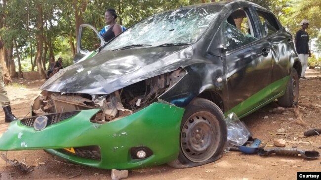 A car is left smashed in Lilongwe, Malawi, on Feb. 24, 2024, after an armed group attacked supporters of the nation's main opposition party.