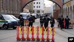 Security officers stand near a roadblock prior to arrivals for the Munich Security Conference at the Bayerischer Hof Hotel in Munich, Germany, Feb. 16, 2024. 