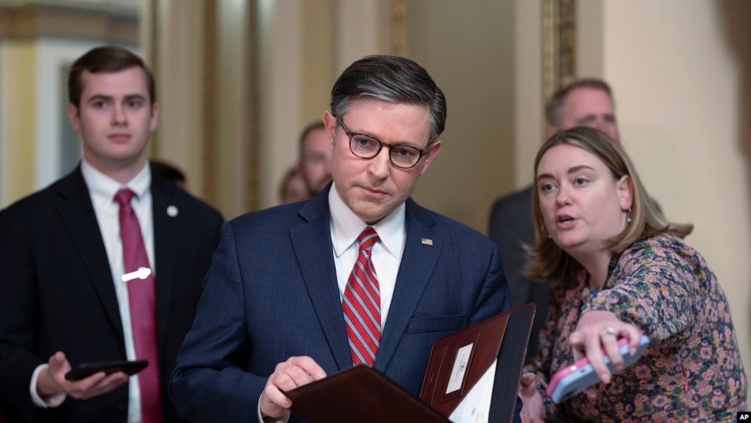 Speaker of the House Mike Johnson , center, stops to talk to reporters just after lawmakers pushed a $95 billion national security aid package for Ukraine, Israel and other U.S. allies closer to passage, at the Capitol in Washington, April 19, 2024. 