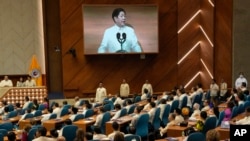 Philippine President Ferdinand Marcos Jr. is shown on an electronic board as he delivers his second state of the nation address at the House of Representatives in Quezon City, Philippines, July 24, 2023.