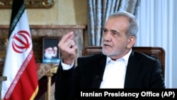 FILE - Iranian President Masoud Pezeshkian speaks in a live televised interview by state TV, at his office in Tehran, Iran, Aug. 31, 2024. (Iranian Presidency Office via AP)