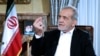 In this photo released by the Iranian Presidency Office, President Masoud Pezeshkian speaks in a live televised interview by state TV, at his office in Tehran, Aug. 31, 2024.