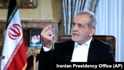 In this photo released by the Iranian Presidency Office, President Masoud Pezeshkian speaks in a live televised interview by state TV, at his office in Tehran, Iran, Aug. 31, 2024. (Iranian Presidency Office via AP)