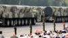 FILE - Military vehicles carrying intercontinental ballistic missiles travel past Tiananmen Square during the military parade marking the 70th founding anniversary of People's Republic of China, in Beijing, Oct. 1, 2019.