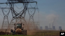 FILE - The land is plowed under electrical pylons leading from a coal-powered electricity-generating plant east of Johannesburg, South Africa, on Nov. 17, 2022. 