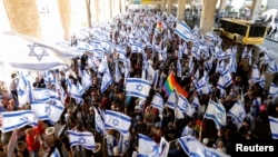 People demonstrate as a response to Israeli Prime Minister Benjamin Netanyahu and his nationalist coalition government's proposed judicial changes, in Lod, Israel, July 11, 2023. Air force reservists have threatened to stop volunteering for service if the changes take place.